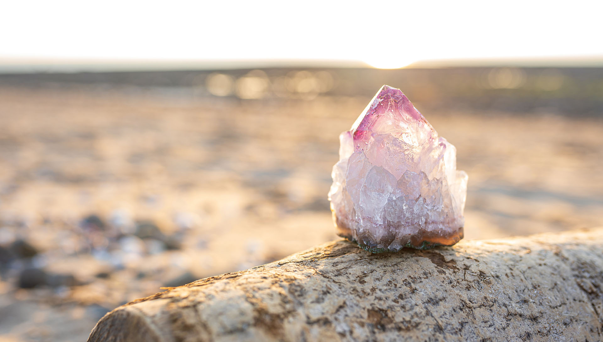 Single raw amethyst gemstone on wood, sunset background, copy space amazinGRACE